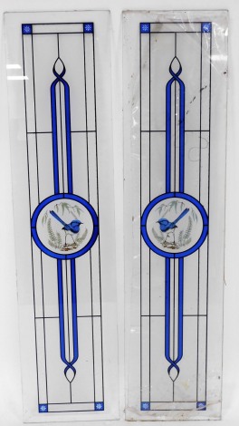 Two modern stained glass panels, each with blue motif, over central panel, 103cm x 23cm.