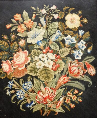 An Edwardian embroidery panel, with a walnut border on a blue ground with floral spray, 29cm x 30cm.