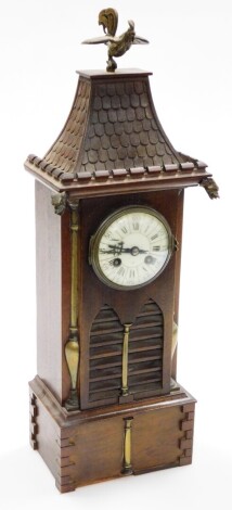 An oak cased temple dragon mantel clock, with a domed enamel dial stamped K-DEPOSE, with dragon and cockerel finials, 51cm high, 15cm wide, 10cm deep.