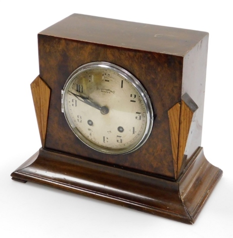 A Bravingtons Renown Art Deco style walnut mantel clock, with two colour walnut panelling and silvered dial, 24cm high, 26cm wide, 16cm deep.