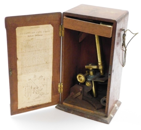 A brass student's microscope, in wooden case stamped Field & Sons Birmingham.