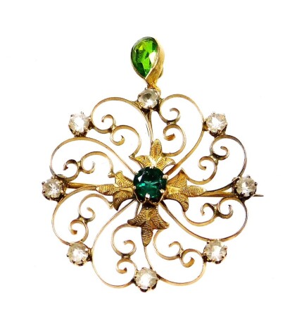 An Art Nouveau style pendant, with a tear drop peridot drop, set with border of white stones, yellow metal, unmarked, 3cm wide, 3.9g all in.