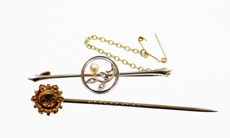 A bar brooch and stick pin, the bar brooch with white metal detailing, set with seed pearls and diamonds, on yellow metal back, stamped 15ct plat, 5cm wide, with safety chain, 3.7g, and a gilt pin. (2)