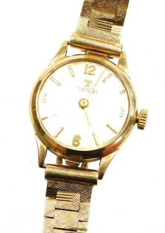 A Tissot 9ct gold wristwatch, with silvered dial, on bark effect bracelet, the dial 1.6cm wide, 20.1g all in.