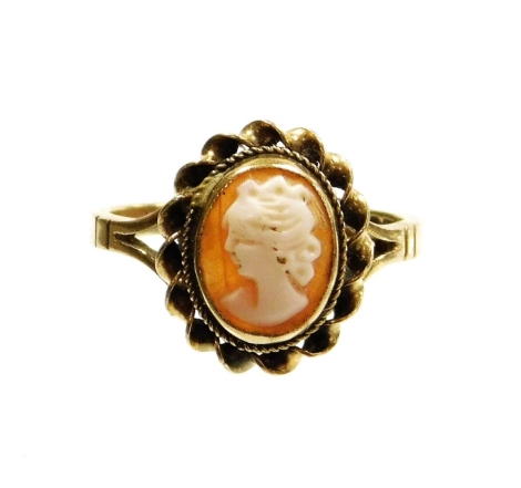 A 9ct gold cameo dress ring, with oval cameo with rope twist border and V splayed shoulders, ring size M½, 2.5g all in.