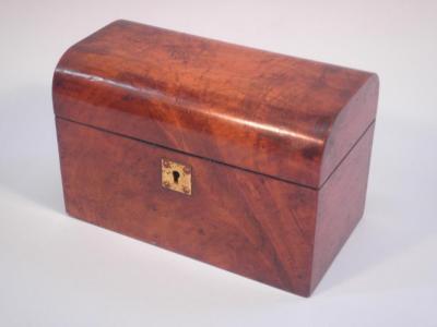 A Victorian figured walnut tea caddy with a domed lid