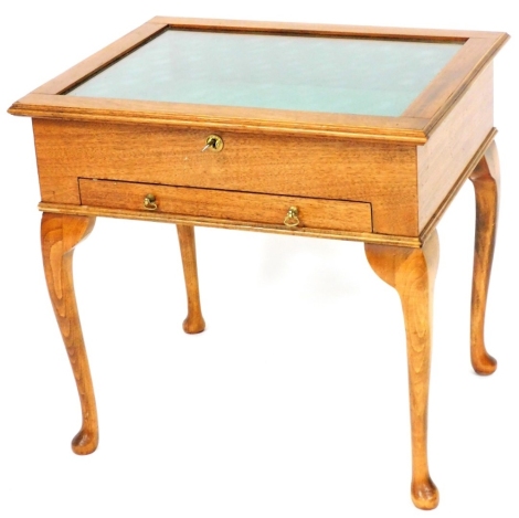 A mahogany display case, with green velvet lined interior above a single drawer, with two keys, 54cm high, 57cm wide, 45cm deep.