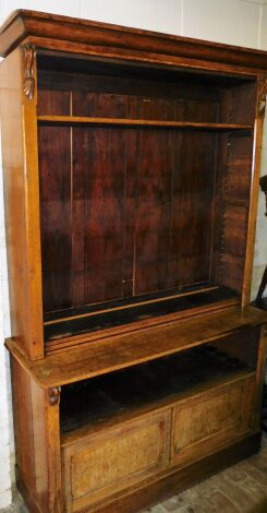 A Victorian oak dresser bookcase, with moulded cornice on floral turned finials, above three shelves, on a cupboard base with two sliding doors, 224cm high, 145cm wide, 50cm deep.