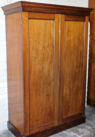 A Victorian mahogany two door wardrobe, with cornice top above two doors on plinth base, 178cm high, 117cm wide, 60cm deep.