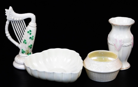 A group of third green mark period Belleek wares, including a heart shaped dish, a Cleary sugar basin, a Georgian shell violet vase and a Irish harp ornament decorated with green shamrock, 1965-1981 . (4)