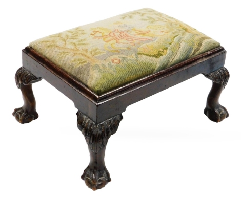 A Chippendale style mahogany footstool, with needlework top and ball and claw feet.