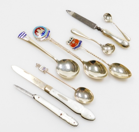 A group of silver and other wares, to include a group of silver and enamelled souvenir spoons, a silver and mother of pearl handled pen knife, a silver plated and mother of pearl pen knife, a silver handled file, silver mustard spoons, etc., weighable sil