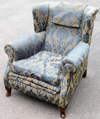 A Victorian armchair, upholstered in a grey and blue floral upholstery on walnut legs, with later back legs, 75cm high, 90cm wide, 94cm deep.