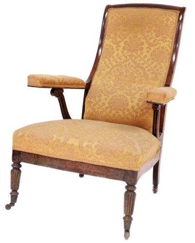 A Regency rosewood library open armchair, in the manner of Jas. Shoolbred & Co., with high scrolling back, fluted scroll arm supports in Damask upholstery, over upholstered seat on slender turned and fluted legs with brass castors. Provenance: Newbold Pac