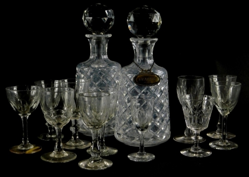 A pair of cut glass decanters and stoppers, and one silver decanter label for brandy, with beaded borders, 26cm high, and various 19thC and later drinking glasses, mainly sherry or port, of varying designs.