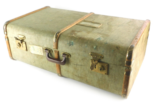 A green canvas and wooden bound suitcase or travel trunk, with brass effect metal mounts, British Railway luggage label for a journey from Cromer Beach to Borehamwood and Elstree, etc., 76cm wide.