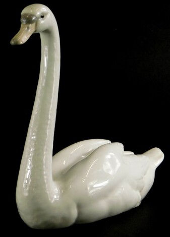 A Lladro porcelain figure of a swan, 22cm long.