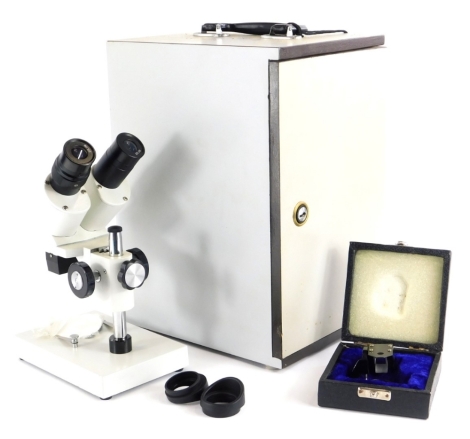 A microscope, with cream enamel paint, the lenses stamped WF10x, in fitted case.