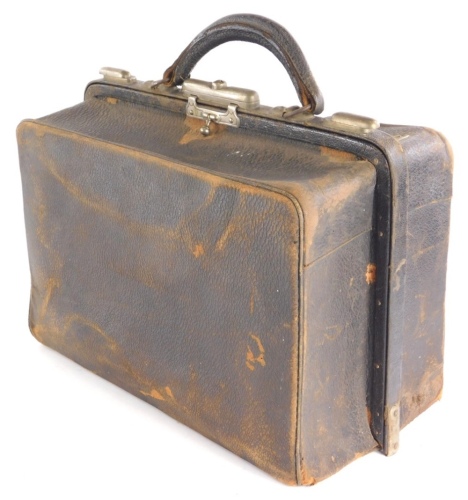 A brown leather Gladstone style travel bag, with fitted pigskin interior for gentleman's toiletries, etc.
