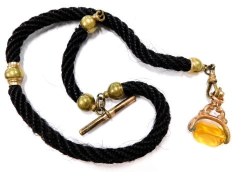 A Victorian mourning jewellery watch fob, the chain of woven hair in three sections, with a rose coloured rolled gold swivel fob with citrine and T-bar, 47cm long.