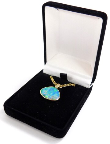 An opal and diamond pendant and chain, the opal doublet in a yellow metal surround stamped 585 14ct, with three diamond set top, on a gold plated chain, the pendant 2cm wide x 2.5cm high, with original purchase receipt, stating ct weight of 3.5ct of opal 