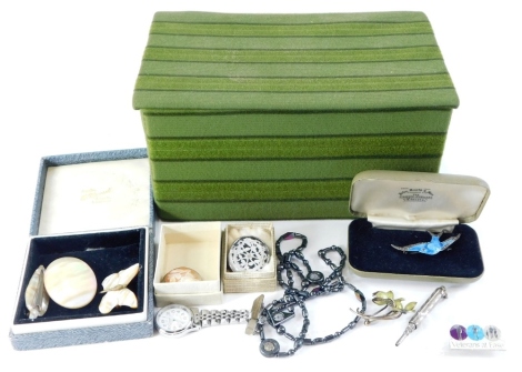 A quantity of costume jewellery, to include mother of pearl brooches, a nurses watch brooch, an enamelled and silver floral brooch, a blue enamel marcasite set silver bird and various other brooches and necklaces. (a quantity)