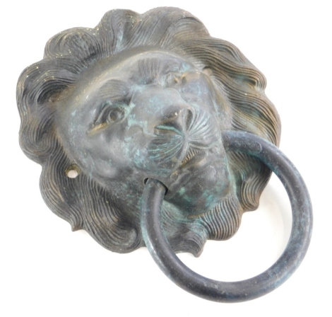 A bronze door knocker, cast in the form of a lion mask with a ring, 15cm wide.