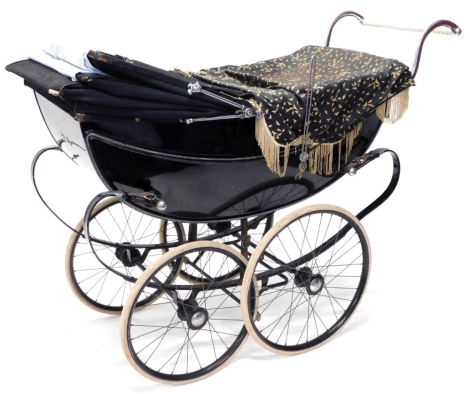 A coach built Silver Cross baby pram, in black and white livery, 140cm long.