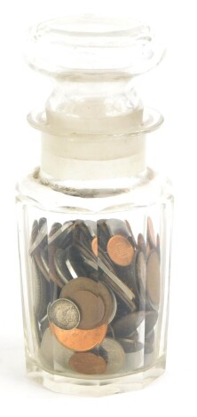 A quantity of British coins, to include a small amount of silver, and a glass jar with faceted sides.