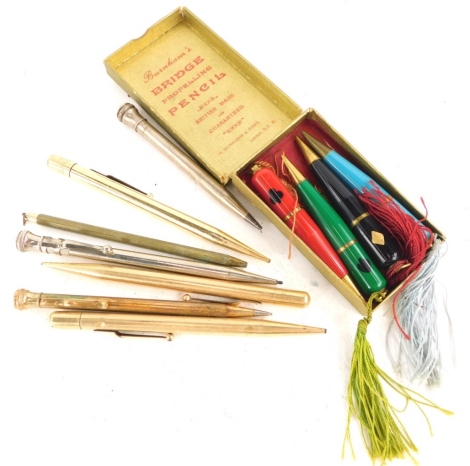 A set of four Burnham's bridge propelling pencils, and various gold plated and other propelling pencils.