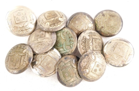 A collection of silver plated livery buttons, each decorated with a crest.