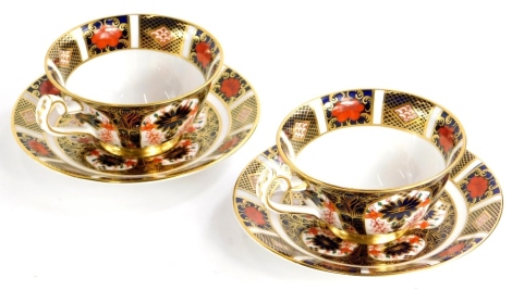 A pair of Royal Crown Derby porcelain cups and saucers, each decorated with the 1128 Imari pattern.