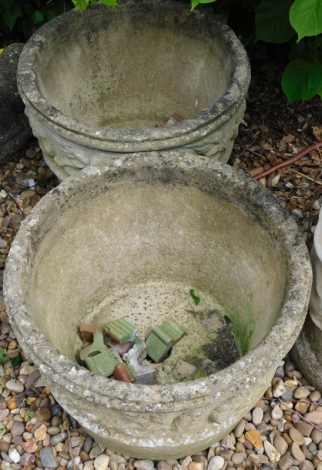 A pair of composition garden planters, each with a moulded border, 41cm diameter.