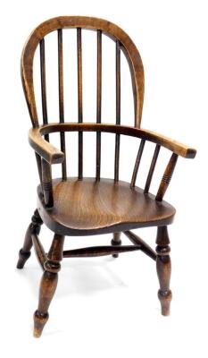 A 19thC ash and elm child's Windsor chair, with spindle turned supports on turned legs with H stretcher.