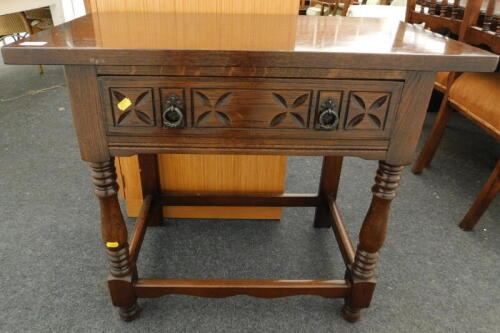 An oak Priory style side table, 70cm high, 82cm wide, 42cm deep.