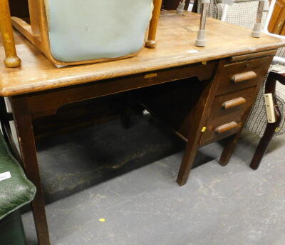 An oak office desk, with three drawers, the top 120cm x 68cm.