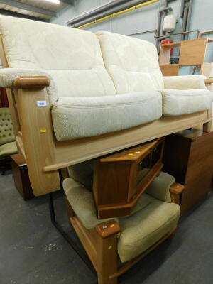 A modern lightwood framed three seater sofa, a similar armchair, and a corner TV stand.