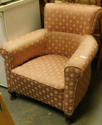 An Edwardian tub chair, upholstered in pink fabric.