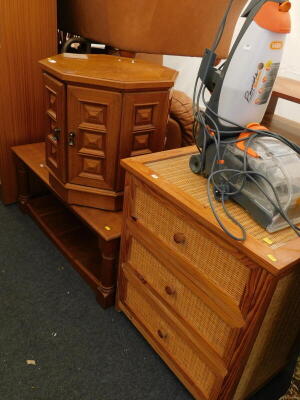 A two tier coffee table, and a teak coffee table/cabinet, a three drawer wicker and pine framed chest of drawers, and a Vax upright carpet cleaner.