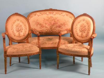 A 20thC gilt wood and gesso French style sofa and two matching open armchairs