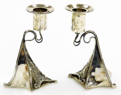 A pair of Arts and Crafts style silver candlesticks, with tapered stem, on shaped body with artistic applied scroll detailing, maker's stamp MJ, Edinburgh, on weighted bases, 13cm high, 12oz gross. - 2