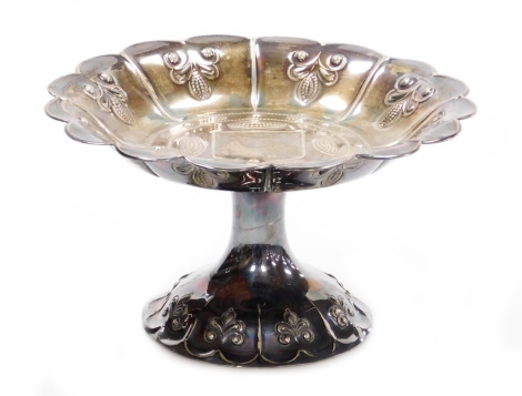 A George V silver sweet meat dish, with fluted body with raised embossed detailing, maker J D and S, London 1931, 10cm high, 12½oz of weighted silver.