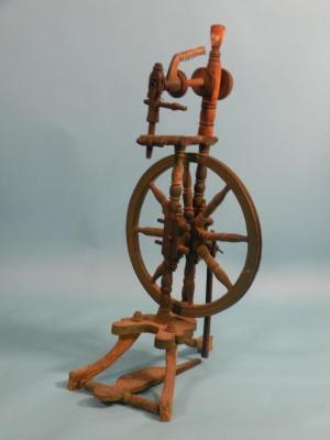 A 19thC green painted spinning wheel of turned form