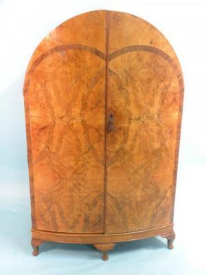 A small walnut dome-top wardrobe in Art Deco style