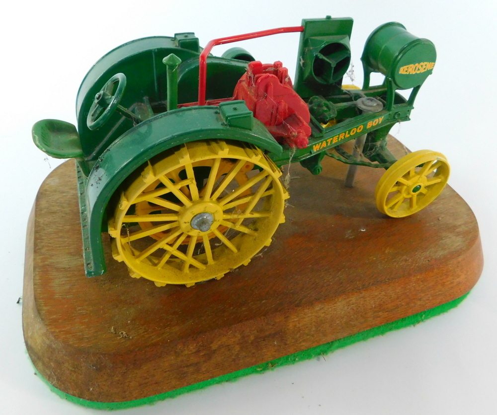 A die cast model of a Kerosene Tractors Waterloo Boy, trophy mounted on
