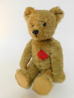 A Schuco model of a Tricky Teddy Bear, with golden mohair, moveable head and tail, silk and plastic tags, wind-up movement, 53cm high. (AF)