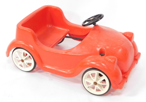 A Tri-ang red pedal car, 68cm wide.