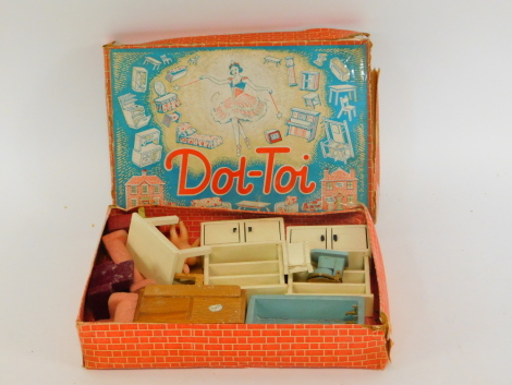 A Dol-Toy Set, mid century, comprising sideboard, bath, two dressers, toilet, table and chair, sofa and pair of armchairs, chimney and two dolls, boxed.