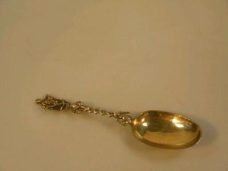 A continental silver gilt spoon with nautical figure to knop and inscribed