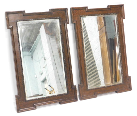 A pair of oak rectangular wall mirrors, each with a bead and reed border, 89cm x 59cm.